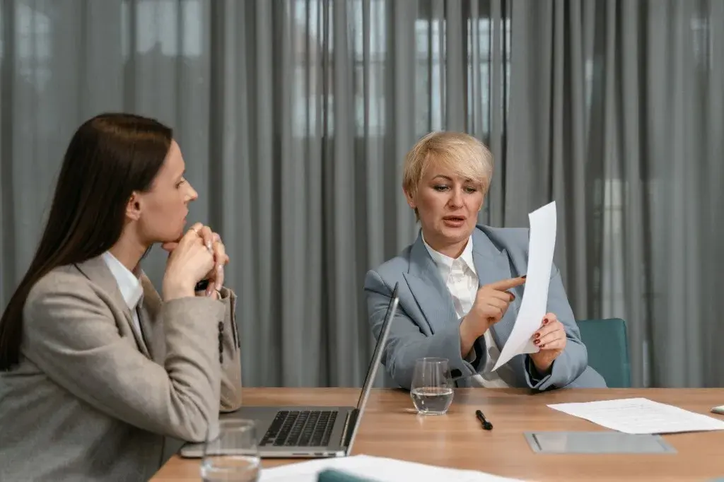 Expert reviewing a document with a client during a professional consultation